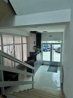 a stairway leading to a building with a parking lot at Prenoćište Stanica in Bosanska Krupa