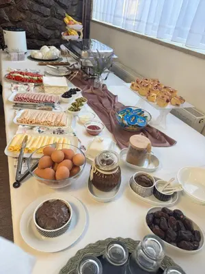 a table with many different types of food on it at Prenoćište Stanica in Bosanska Krupa