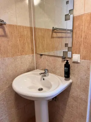 a bathroom with a white sink and a mirror at Prenoćište Stanica in Bosanska Krupa