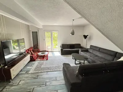 a living room with a couch and a flat screen tv at Peace Holiday Home in Bihać