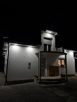 a white building with lights on it at night at Peace Holiday Home in Bihać