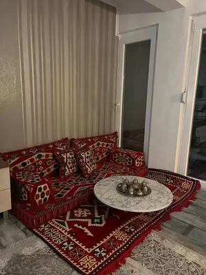 a living room with a red couch and a table at Peace Holiday Home in Bihać