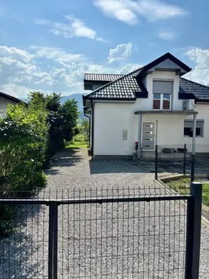 a white house with a black roof at Peace Holiday Home in Bihać