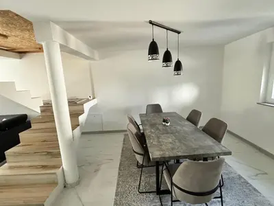 a dining room with a table and chairs at Peace Holiday Home in Bihać