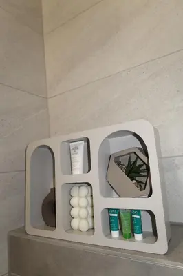 a bathroom with a mirror and someental products on a counter at Lumière Apartment in Banja Luka