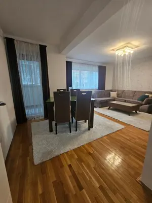 a living room with a table and chairs and a couch at Apartment STELLA in Bihać