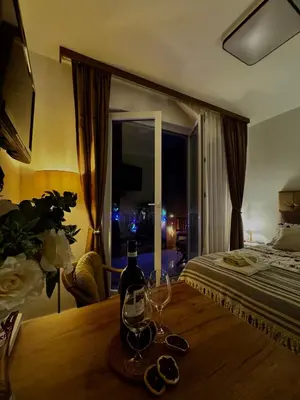 a bedroom with a bed and a table with wine glasses at Apartment Rosa Brandis in Travnik