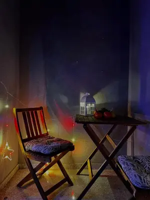 a table with a chair and a table with a lamp at Apartment Rosa Brandis in Travnik