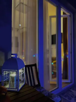 a blue lantern sitting on top of a table next to a window at Apartment Rosa Brandis in Travnik
