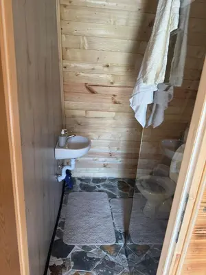 a bathroom with a toilet and a sink at AM Pyramid resting in Visoko
