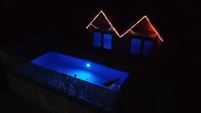 a house with a swimming pool in the dark at AM Pyramid resting in Visoko