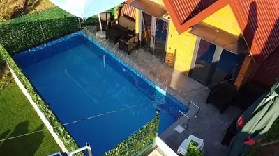 an overhead view of a swimming pool next to a house at AM Pyramid resting in Visoko