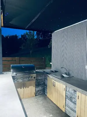 a outdoor kitchen with a grill and a sink at Elmo Oasis in Banovići