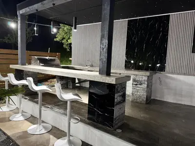 a outdoor bar with white stools and a grill at Elmo Oasis in Banovići