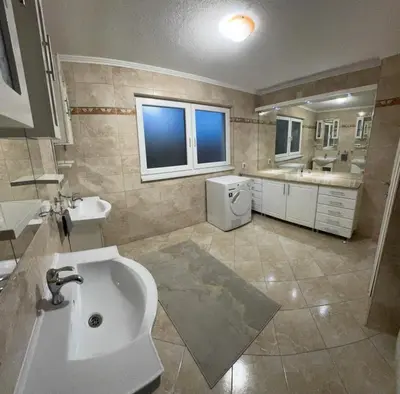 a large bathroom with a sink and a tub at Elmo Oasis in Banovići