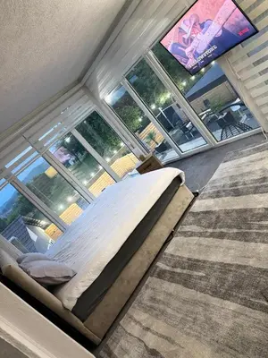 a bed in a room with a large window at Elmo Oasis in Banovići