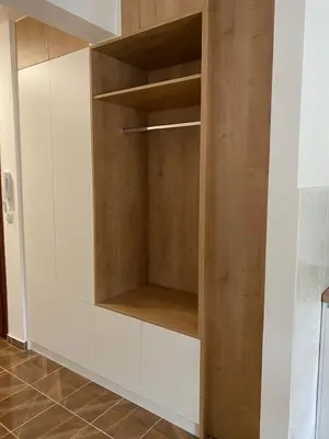 a cupboard in a kitchen with wooden shelves at Prima in Bosanska Dubica