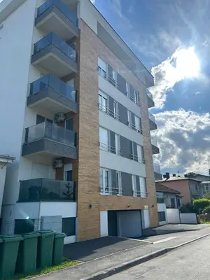 an apartment building with balconies on a street at Prima in Bosanska Dubica