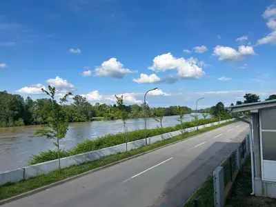 a road next to a river with a bridge at Prima in Bosanska Dubica