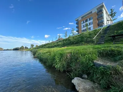 a building on a hill next to a river at Prima in Bosanska Dubica