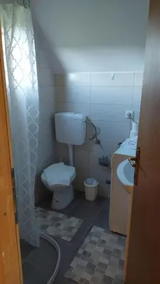 a small bathroom with a toilet and a sink at Brvnara N&N in Laktaši