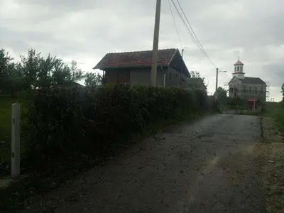 a dirt road next to a house and a building at Vikendica Mihajlovic TUL in Čifluk