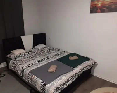 a bedroom with a bed with a blanket on it at Vikendica Mihajlovic TUL in Čifluk