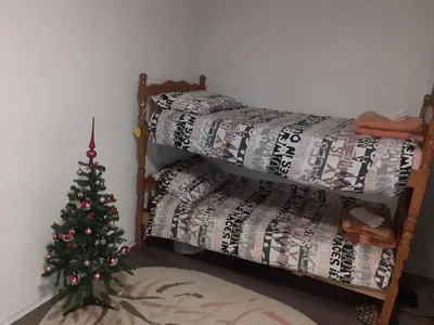 a room with a christmas tree and a bed at Vikendica Mihajlovic TUL in Čifluk
