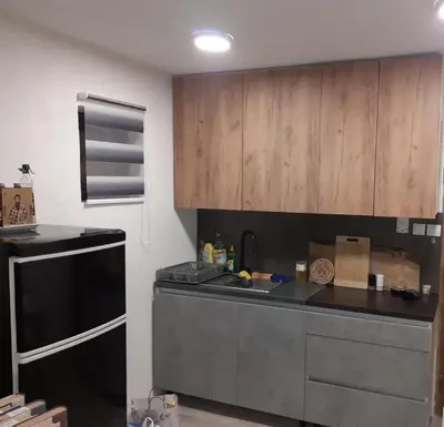 a kitchen with a black counter and wooden cabinets at Vikendica Mihajlovic TUL in Čifluk
