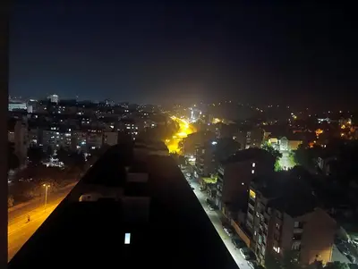a view of a city at night with lights at CityComfort Tuzla in Tuzla