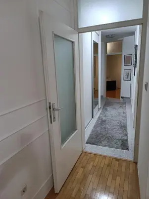 an empty hallway with a door and a mirror at CityComfort Tuzla in Tuzla