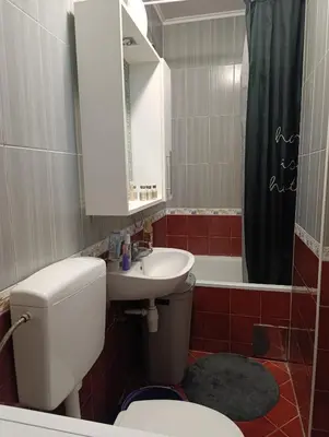 a bathroom with a toilet and a sink and a mirror at CityComfort Tuzla in Tuzla