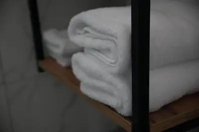 a pile of towels sitting on a shelf at Studio apartman Ivica in Jajce