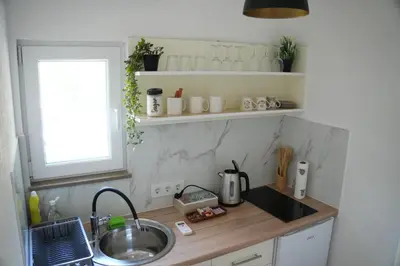 a kitchen counter with a sink and a window at Studio apartman Ivica in Jajce