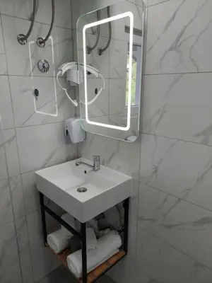 a bathroom with a sink and a mirror and towels at Studio apartman Ivica in Jajce