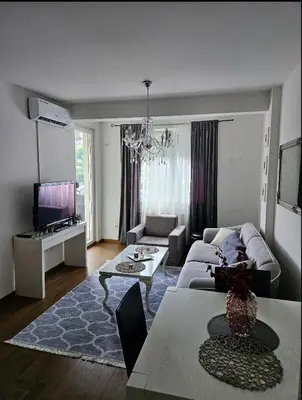 a living room with a couch and a table at Comfort pored Klinickog Centra in Banja Luka