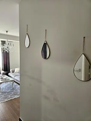 a living room with two mirrors on the wall at Comfort pored Klinickog Centra in Banja Luka