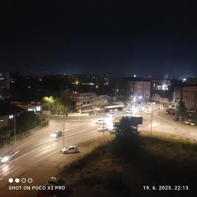 a city street at night with cars on the road at Comfort pored Klinickog Centra in Banja Luka