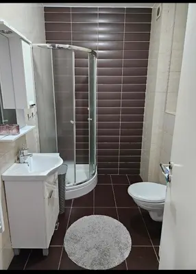 a bathroom with a shower and a sink and a toilet at Comfort pored Klinickog Centra in Banja Luka