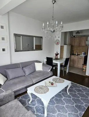 a living room with a couch and a table at Comfort pored Klinickog Centra in Banja Luka