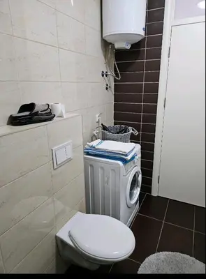 a bathroom with a toilet and a sink at Comfort pored Klinickog Centra in Banja Luka