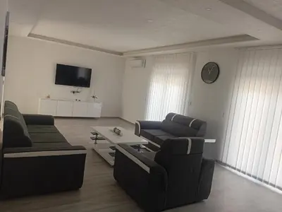 a living room with two couches and a tv at Apartman Volijak 44 in Jajce