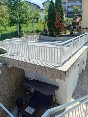 a deck with a soaking tub on a patio at Apartman Volijak 44 in Jajce