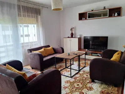 a living room with couches and a flat screen tv at Relax Rose Apartment in Kulen Vakuf
