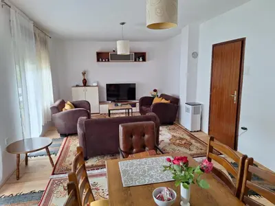a living room with a couch and a table at Relax Rose Apartment in Kulen Vakuf