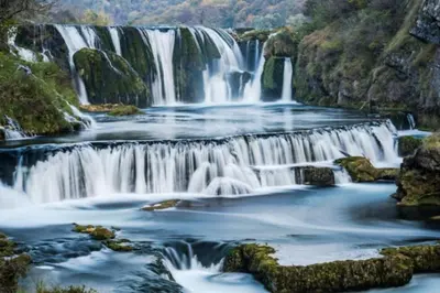 a waterfall in the middle of a river at Relax Rose Apartment in Kulen Vakuf