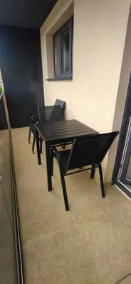 a black table and chairs in a room at Apartman Bonaca in Kiseljak