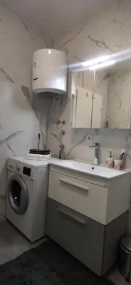 a kitchen with a sink and a washing machine at Apartman Bonaca in Kiseljak