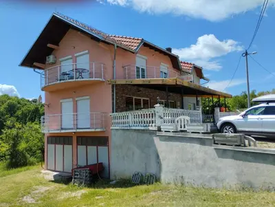 a house with a car parked in front of it at Lillis Apartment in Ivišovo Greblje