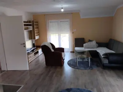 a living room with a couch and a table at Lillis Apartment in Ivišovo Greblje